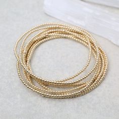 Whether worn alone for a touch of understated luxury or stacked with other bracelets for a bold statement, these Ball Bead Bracelets add a touch of glamour to any outfit, for any occasion. Made to be worn in the pool, shower, ocean, or wherever your bohemian adventures take you. Waterproof | Tarnish Free | Hypoallergenic Classic 2mm beads Options: 14K gold filled, Sterling Silver, or Two Tone High Performance Elastic Made in Miami Gold Multi-strand Stackable Bracelets, Elegant Gold Stackable Wrap Bracelet, Elegant Stackable Stretch Bracelet For Party, Gold Beaded Bracelets With Tiny Beads For Party, Gold Multi-strand Stackable Jewelry, Gold Stretch Bracelet With Faceted Beads For Party, Flexible Gold Beaded Bracelets With Tiny Beads, Flexible Gold Bracelet With Tiny Beads, Gold Multi-strand Stackable Beaded Bracelets