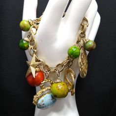 *Description: This is a beautiful charm vintage bracelet from around the 1960s.  The bracelet is gold plated and has Lucite beaded charms, a blue Lucite robins egg charm, a gold tone snake charm with faux pearl, a star, coin charms, and an initial charm which may be TSE.  I'm not sure about the initials, as it could just be a design.  The bracelet weighs about 2.1 ounces.  It is very retro and would look great with your favorite outfit. Spring ring clasp. This would be a great addition to your vintage jewelry collection or make a great vintage gift! *Approximate Measurements: Length - 7 Inches *Condition: Very good vintage condition.  Will see signs of wear under magnification. See photos for details. *Hallmark:  Unsigned *Item # P1594 Please look at the photos carefully as they are a part Beaded Charms, Vintage Bracelet, Robins Egg, Bracelet Vintage, Initial Charm, Vintage Bracelets, Gold Plated Chains, 1960s Vintage, Vintage Gifts