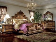 a bedroom with a bed, dressers and chandelier in the middle of it