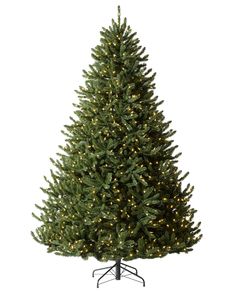 a large christmas tree with lights on it's branches and a black stand in front of a white background