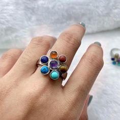 Chakra ring,Rainbow ring,Adjustable ring,Silver plated ring, Gemstones: Amethyst,tigers eye,lapis lazuli,green turquoise,natural turquoise,orange aventurine,red agate.Size: Adjustable.Material: Silver plated, Natural gemstones. You receive an exact ring like the ones shown in the pictures.Amethyst has healing powers to help with physical ailments, emotional issues, and in Energy Healing and Chakra balancing. Amethyst crystal therapies are primarily associated with physical ailments of the nervou Adjustable Multicolor Stone Rings, Healing Natural Stones Open Crystal Ring, Adjustable Spiritual Amethyst Ring With Natural Stones, Unique Adjustable Crystal Healing Ring, Adjustable Rainbow Gemstone Ring, Adjustable Multicolor Crystal Ring, Gomti Chakra Ring, Orange Gemstone Spiritual Rings, Adjustable Multi-stone Crystal Ring Gift