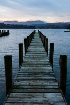 a wooden dock sitting on top of a body of water