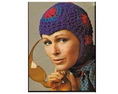 a woman wearing a knitted hat holding a teapot