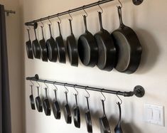 pots and pans are hanging on the wall