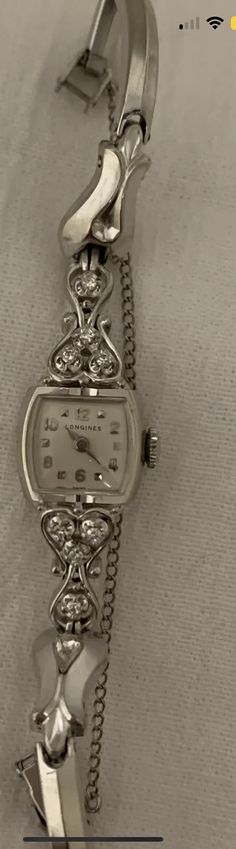 This is a gorgeous ladies 14kt white gold and diamond watch from Longines. Excellent condition.  Wind up.  Produced in 1955. Vintage Watches With Single Cut Diamonds For Anniversary, Vintage Diamond Watch With Diamond Accents For Anniversary, Classic White Gold Jewelry With Brilliant Cut, Vintage Diamond White Jewelry And Watches For Anniversary, Vintage Diamond Jewelry And Watches As Gifts, Vintage Diamond Wedding Watch, Elegant Silver Jewelry And Watches For Anniversary, Vintage Diamond Watch With Diamond Accents For Formal Events, Vintage Diamond Watch With Diamond Accents For Formal Occasions