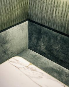 the corner of a room with a marble table