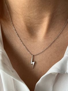 Lightning of the night ⚡ Get this beautiful minimalist jewelry made with the quality of perfect elements✨ You can choose 925K Sterling Silver with the options of Gold, Rose Gold or White Gold colors High quality jewelry for everyone 🤍 Details * 925K Sterling Silver Option → 14K Gold, Rose Gold or White Gold plated * Chain length is approximately 18 inches (16+2 in extender) / 45 cm (40+5 cm extender) * Time is everything! You will receive your package as soon as possible 🚚 * We care about the quality of metal to make sure it will last for a long time * We use enamel technique to color the jewelry and high quality zircons only * There can be tiny differences on each item. Length difference of the chain as well as color changes and shade differences of the stones and enamel is possible sin Minimalist Sterling Silver Tarnish Resistant Jewelry, Minimalist Sterling Silver Charm Necklaces, Tarnish Resistant, Minimalist Sterling Silver Charm Necklaces, Minimalist Sterling Silver Charm Necklace Tarnish Resistant, Minimalist Sterling Silver Charm Necklace, Tarnish Resistant, Sterling Silver Simple Design Jewelry Gift, Simple White Gold Jewelry With Polished Finish, Simple Polished White Gold Jewelry, Minimalist White Gold Charm Necklace With Clavicle Chain