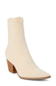 A pointy toe, Cuban heel and curvy topline reflect the Western-influenced design of this ankle boot made with a stretchy knit upper. 2 1/2" heel; 1/2" platform 8" shaft Pull-on style Textile upper/synthetic lining and sole Imported Cream Pointed Toe Fitted Boots, Fitted Cream Boots With Pointed Toe, Fitted Cream Pointed Toe Boots, Cream High Heeled Boots, Fitted Cream High Heel Boots, Cream Colored Fitted Heeled Boots With Pointed Toe, Fitted Heeled Boots With Sculpted Heel For Fall, Cream Heeled Boots With Reinforced Heel, Fitted Cream Heeled Boots With Reinforced Heel