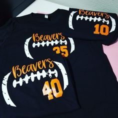 two football shirts with the number forty and beaver's on them sitting on a bed