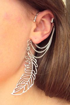 This unusual Feather ear cuff I made for a person who likes cosplay and Elven jewelry. It's a great idea for a Fairytale or Magic style party. No piercing needed to wear this ear cuff. It slips behind your ear and rest against your head with the dangles showing below the massive charm. The upper part of cuff is fake, no need a cartilage piercing. It's very comfortable and easy to wear. Fits both for left and right ears. The length of wing charm is about 2 inches. The price for one ear cuff. More Falling Feathers, Feather Ear Cuff, Earring Cuff, Feather Cuff, Ear Crawler, Elven Jewelry, Cuff Earring, Mixed Metal Jewelry, Silver Ear Cuff