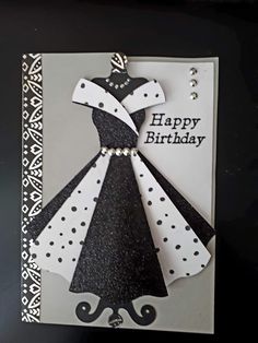 a birthday card with a black and white dress on it