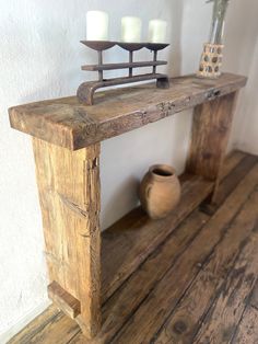 a wooden shelf with candles on top of it