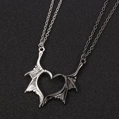 Elevate your love with the Dragon Wing Love Necklace, a symbol of unique and everlasting affection. Crafted with meticulous detail, this stunning piece features two intricately designed dragon wings, united in perfect harmony. Each wing is expertly crafted from premium quality metal and polished to a gleaming finish, creating a captivating and eye-catching accessory. The Dragon Wing Love Necklace is more than just jewelry; it's a statement of devotion and admiration. Whether you're expressing yo Demon Dragon, Dragon Wing, Necklace Couple, Bff Jewelry, Friendship Necklace, Bracelet Viking, Biker Jewelry, Dragon Necklace, Couple Necklaces