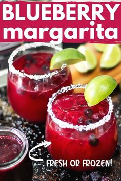 two glasses filled with blueberry margarita on top of a table