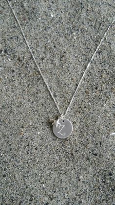 Beautiful. Simple. 12mm sterling silver disk is monogrammed with your initial in either Monogram script or Ariel font. Please see last photo for an example of both fonts. It has a tiny sterling silver puffed star charm hanging beside it. Perfect everyday necklace or for a bridesmaid group! Please message me if you would like more than the quantity listed. I can produce custom orders of any quantity. Also available in gold with silver star as seen in last photo and available here: https://www.ets Silver Star Charm Necklaces For Anniversary, Silver Star Charm Necklace For Anniversary, Dainty Silver Initial Necklace For Birthday, Elegant Silver Hand Stamped Charm Necklaces, Sterling Silver Initials Charm Necklace For Birthday, Sterling Silver Initials Charm Necklace For Birthdays, Silver Minimalist Initial Necklace For Birthday, Silver Monogram Initial Pendant Charm Necklace, Silver Sterling Initials Charm Necklace