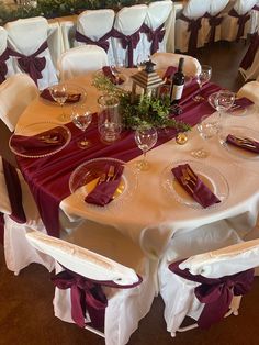 the table is set with wine glasses and place settings