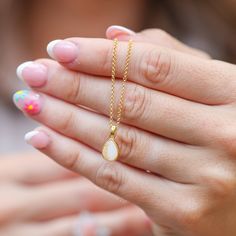 As the years go by and the phases of motherhood evolve, The Last Drop will remain a cherished keepsake, with the actual last drop of your breastmilk forever encapsulated within the stone. Shaped like a gentle teardrop, this necklace signifies the profound emotions that accompany the final moments of breastfeeding—a blend of bittersweet endings and sacred memories that are preserved within its delicate form. The Last Drop necklace and matching ring were named by my very own mama, Anne Plage. Elegant Drop Keepsake Necklaces, Elegant Drop-shaped Keepsake Necklaces, Elegant Drop Necklaces For Keepsakes, Elegant Keepsake Drop Necklace, Minimalist White Keepsake Necklace, White Jewelry With Birthstone For Keepsake, Dainty Teardrop Pendant Necklace With Natural Stones, Teardrop Birthstone Jewelry For Healing, White Birthstone Jewelry For Keepsake