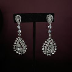 Our MARQUISE Earrings with Swarovski Crystals are Absolutely Stunning. MARQUISE Drop Bridal Earrings can add glitter and glamour to your amazing special day. Handcrafted Unique Design Highest Quality & Finest Materials Brilliant SWAROVSKI Crystals Cubic Zirconia Rhodium / Platinum plated gives a luxurious shine and luster. It has a brilliant silver tone and guards against scratches and tarnish. Earrings Drop Length is approx. 2.25 in (5.7 cm) FREE Shipping in USA. If Out of Stocks or made to Formal Sparkling Crystal Bridal Earrings, Crystal Drop Earrings For Bridal Glamorous Events, Crystal Drop Earrings For Glamorous Events, Bridal Diamond Drop Earrings With Rhinestones, Luxury Diamond Crystal Earrings For Wedding, Bridal Dangle Earrings With Diamonds And Rhinestones, Formal Bridal Earrings With Rhinestones In Diamond White, Diamond Dangle Bridal Earrings With Rhinestones, Diamond Bridal Dangle Earrings With Rhinestones