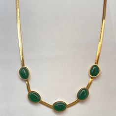 This elegant Gold Plated Snake Chain Faux Emerald Necklace adds a touch of sophistication to any outfit. Featuring a stunning faux emerald pendant, this necklace is perfect for women who want to make a statement. The gold plating adds a touch of luxury, while the snake chain design adds a unique and stylish touch. Material: Brass Necklace Size: 15.0"+2.2"Extension Chain Elegant Green Clavicle Chain Necklace, Green Formal Jewelry Chain, Green Oval Necklace For Party, Elegant Green May Birthstone Chain Necklace, Formal Green Chain Jewelry, Elegant Gold-plated Emerald Clavicle Necklace, Gold Emerald Necklace With Clavicle Chain For Formal Occasions, Formal Gold Emerald Necklace With Clavicle Chain, Gold Emerald Necklace With Adjustable Chain For Formal Events