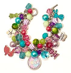 This bright and colorful Easter Bunny themed Charm bracelet is full of Easter cheer. It is made up of various shades of purple, green, hot pink and turquoise beads.  In addition there are 4 single sided enamel bunny charms in 4 coordinating colors, 2 silver tone Happy Easter flower charms and one double sided 18mm bottle charm in the center.  Bracelet is approximately 7.5 inches long. I will be happy to resize the bracelet at no additional charge. Coordinating earrings can be found on a separate Whimsical Multicolor Jewelry With Charms, Whimsical Multicolor Charms Jewelry, Personalized Multicolor Charm Bracelet For Birthday, Themed Multicolor Jewelry With Charms, Multicolor Themed Jewelry With Charms, Multicolor Charms Jewelry For Birthday, Whimsical Multicolor Jewelry For Friendship, Multicolor Charm Jewelry For Birthday, Whimsical Multicolor Personalized Jewelry