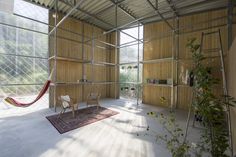 an empty room with a hammock hanging from the ceiling