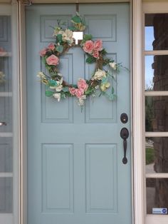 a blue front door with a wreath on it