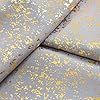 four pieces of white and gold glittered fabric on a bed sheet or comforter