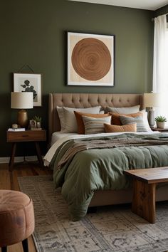 a bedroom with green walls and a large bed in the middle, along with two end tables