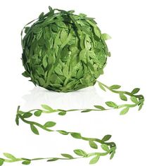 a ball of green paper with leaves on it