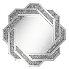 a round mirror with silver glitters on the edges and an intricate design in the middle