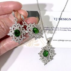 "A unique emerald green bridal jewelry in Victorian wedding style featuring vintage style Damask bridal earrings and Fleur de Lis necklace pendant, made of high quality cubic zirconia in white gold silver rhodium tarnish-resistant finish. You may choose earrings only, necklace only or earrings necklace set. Earrings are 1 1/2\" (4cm) with hooks. Pendant is about 1 3/8\" (3.5cm) with bail. Chain length is 17.5\" (45cm). * Necklace pic on mannequin is the same design but in blue for display purpos Cubic Zirconia Pendant Jewelry Sets For Wedding, Wedding Diamond Pendant Jewelry Sets, Cubic Zirconia Pendant Earrings For Wedding, Diamond Pendant Jewelry Set For Wedding, Elegant Green Pendant Bridal Necklace, Wedding Pendant Jewelry Sets, Green Sparkling Stones Jewelry Sets For Wedding, Fine Jewelry Green Bridal Necklace As Gift, Emerald Jewelry With Matching Earrings For Wedding