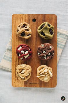 a wooden tray topped with different types of desserts