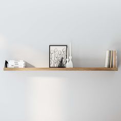 Wallniture Minori Shelf mounted on a wall with minimalistic decor. The shelf holds a few books, a framed picture, and decorative vases, emphasizing its sleek design and versatility in different room settings. Floating Book Shelf, Wall Shelf Display, Wall Bookshelf, Floating Books, Rustic Wall Shelves, Drywall Installation, Floating Wall Shelf, Shelving Solutions, Nursery Shelves