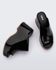 Throwback style meets current trends—that’s just how the Patty rolls. Lightweight and streamlined with a wide strap and a peep toe, these platform mules are true attention seekers, and the contrasting sole detail amps up the cool factor. Made from our revolutionary Melflex® PVC plastic, you enjoy more flexibility and comfort. Plus, they’re 100% recyclable. Modern Platform Slip-on Slides, Modern Wedge Sandals With Contrasting Heel, Modern Black Platform Slippers With Rubber Sole, Trendy Black Open Heel Platform Slippers, Trendy Black Platform Slippers With Open Heel, Summer Clogs With Translucent Outsole, Casual Black Open Heel Platform Slippers, Modern Black Clogs With Rubber Heel Cap, Modern Slides With Rubber Sole And Open Heel