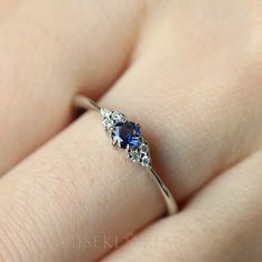 14k Solid Gold Natural Blue Sapphire With Real Diamond Ring, Blue Sapphire Engagement Rings, Sapphire Diamond Ring, Real Sapphire Rings DETAILS ♡⃛ ⃛ Main stone: Blue Sapphire; approx. 3.3-3.4 mm; 0.20ct Side stone: Diamond; 0.06ct Band width: 1.5mm Band thickness: 1.2mm OUR GEMSTONES ♡⃛ ⃛ At Kiseki Kiara, we use both precious and semi-precious stones throughout our jewelry designs, with each stone set-by-hand in our workshop. We carefully source gemstones for their quality and color ensuring you Deep Blue Engagement Ring, 14k White Gold Jewelry With Sapphire In Round Band, Blue Sapphire Ring With Diamond Accents For Promise, Blue Diamond Ring With 14k Gold Accents, Blue Promise Rings With Diamond Accents, Blue Rings With Prong Setting For Promise, Blue Diamond Promise Ring In 14k Gold, Blue Round Band Promise Jewelry, Blue Sapphire Birthstone Ring For Promise