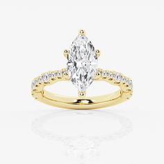 a yellow gold engagement ring with an oval cut diamond in the center and side stones