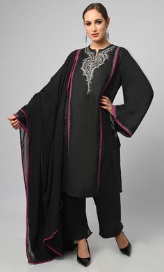 Embroidered black salwar phiran set. It is a detailed and intricate form of contrast piping and zari work embroidered on sleeves, pockets and neck, colorful stitches to create patterns and designs on the fabric of the garment. It is a popular choice for special occasions, such as weddings and festivals. Salwar suits are more modern and casual alternative to the traditional salwar kameez Fabric Details TOP Pure polyster poplin with zari work detailing on neck and sleeves, Full loose sleeves Dupat Transitional Embroidered Long Sleeve Palazzo Set, Black Dupatta With Resham Embroidery In Traditional Drape, Black Dupatta With Resham Embroidery, Festive Long Sleeve Palazzo Set With Embroidered Border, Black Traditional Dupatta For Designer Wear, Black Traditional Designer Dupatta, Designer Black Churidar With Embroidered Border, Black Embroidered Dupatta In Traditional Drape, Black Embroidered Dupatta With Traditional Drape