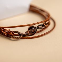 Approx. 14" Handmade in Laurel, Mississippi Beautifully colored natural brown leather with Novi's signature clasp allowing it to snap together with other NoVi bracelets for an original look. Wraps around the wrist twice, or can be worn as a choker. For a looser fit, add an extender! Hand-strung Brown Leather Bracelet Gift, Adjustable Distressed Brown Leather Bracelet, Vintage Brown Adjustable Leather Bracelet, Vintage Distressed Brown Leather Bracelet, Spiritual Brown Hand-strung Leather Bracelet, Brown Leather Bracelet, Natural Brown, Mississippi, Brown Leather