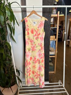 Vintage yellow floral dress, with pink and peach hues. Tag marked size 14. Length: 42" Bust: 22" *Please note that each vintage item is unique & preloved, so garments may come with slight imperfections. All vintage items are final sale Peach Floral Print Maxi Sundress, Peach Floral Print Sundress Maxi Dress, Orange Vintage Dress For Spring, Pink Floral Print Vintage Dress, Pink Vintage Floral Dress For Summer, Long Vintage Summer Dress, Apricot Floral Print Maxi Dress For Garden Party, Spring Apricot Maxi Dress With Floral Print, Apricot Fitted Vintage Dresses