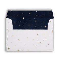 a white envelope with gold stars on it