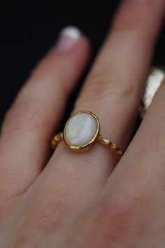 Opal ring, dainty opal gold filled ring for women. High quality Australian opal. Nice present for her. Available of different materials: -Rhodium plated sterling silver* -18k gold filled sterling silver -18 solid gold *Rhodium layer is used to make silver shine for a long time. Please, make sure you don't have allergy on rhodium. Size:  Please, choose the size you need. We use US sizes from 5-10. Our Ring Guide will help you to find the right size. If you don't see your size on the list or you h Opal Ring Aesthetic, Large Opal Ring, Minimalist Oval Cabochon Opal Ring For Anniversary, Minimalist Oval Opal Ring For Gift, Minimalist Oval Opal Ring Gift, Minimalist Opal Ring With Bezel Setting As Gift, Elegant Opal Oval Cabochon Ring Gift, Elegant Oval Cabochon Opal Ring Gift, Elegant Opal Ring With Oval Cabochon