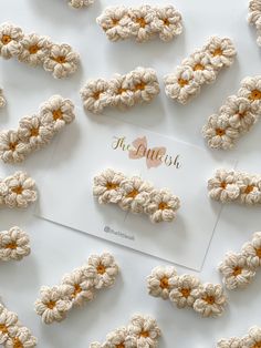 there are crocheted flowers on top of a card with the name of the guest