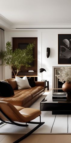 a modern living room with leather furniture and art on the wall, including a coffee table