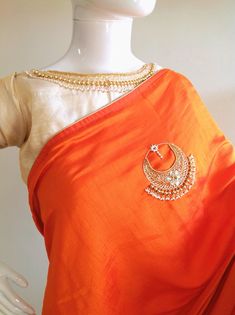 "Stunning orange semi silk saree with intricate all over chaandbali design hand embroidery and rawsilk tissue offwhite unstiched blouse with matching necklace embroidery atvthe neck and handworked sleeve borders. The embroidery on the saree is just beautiful, classy and truly a work of art. And, guess what, you dont need a neck piece to go with this. The fantastic embroidery on the blouse is so beautiful and makes this a unique piece. Saree length 5.5 meters Blouse fabric 1 meter 44\" wide Saree Designer Orange Cutdana Dupatta, Orange Cutdana Dupatta For Designer Wear, Orange Saree With Dori Work, Orange Zari Work Pre-draped Designer Saree, Orange Zari Work Pre-draped Saree For Designer Wear, Orange Designer Saree With Dori Work, Tissue Silk Chandbali Dupatta With Cutdana, Tissue Silk Dupatta With Gota Work For Puja, Tissue Silk Traditional Wear With Gota Work For Puja