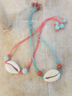 Cowrie Shell Necklaces/Bracelets - Assorted colors - Summer Indigo Bohemian Bracelet With Adjustable Cord, Bohemian Coral Jewelry For The Beach, Bohemian Coral Jewelry For Beach, Coral Bohemian Beach Jewelry, Adjustable Coral Bracelets With Round Beads, Coral Beach Bracelet Jewelry, Coral Bracelet Jewelry For Beach, Adjustable Coral Beaded Jewelry, Multicolor Sliding Knot Jewelry For Gifts