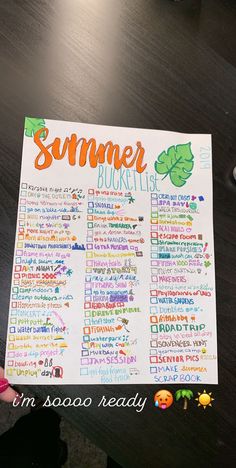 a person holding up a summer bucket list