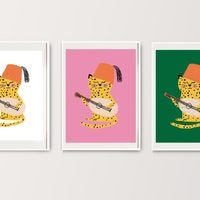 three framed art prints with animals on them, one has a guitar and the other is a leopard