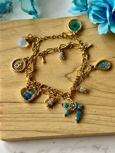 Floral personalized .925 silver gold plated various blue flowers, double chain charm bracelet, real blue dried flowers charm, initial charm, heart charm with blue flowers, rhinestone charms, acrylic blue bead charm, lobster claw clasp, moonstone charm, perfect for Mother's Day gifts, birthday gifts, wedding gift ("something borrowed, something blue"), this bracelet is 7 inches in length. Dainty Flower Charm For Gift, Dainty Flower Charm Jewelry For Mom, Dainty Flower Charm Jewelry As Gift For Mom, Dainty Jewelry With Flower Charm As Gift For Mom, Charming Flower Charm Jewelry As Gift, Charming Flower Charm Jewelry For Gift, Dainty Charms With Lobster Clasp For Gifts, Charming Gold Charm Bracelet As Gift, Blue Flower Charm Jewelry As Gift For Her