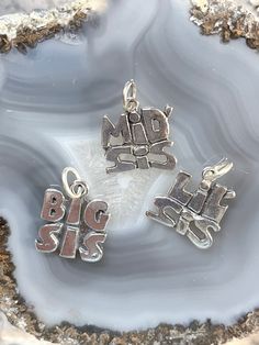 Sterling Big Sis charm, Sterling Mid Sis charm, Sterling Lil sis charm, Sterling Sister charm, Silver family charms, sterling Sorority charm Please view ALL pics for size and details Charms may pose a choking hazard These Sterling Sister charms are a perfect gift for a sibling or for that special Sorority sister!  Each charm is a bit  heavier weight and would be beautiful on a sterling silver chain or attached to your favorite charm bracelet. Our charms can be paired with your unique stampings, Personalized Silver Dangle Charms, Sterling Silver Dangling Charms For Personalized Gifts, Personalized Silver Charms For Mother's Day, Collectible Nickel-free Sterling Silver Charms, Sterling Silver Pendant Charms For Mother's Day, Silver Dangling Charms For Mother's Day, Mother's Day Silver Dangling Charms, Personalized Sterling Silver Charms For Mother's Day, Sterling Silver Charms For Mother's Day Personalized Gift