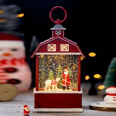 a christmas scene with santa claus and his horse in a barn shaped ornament